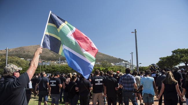 A protester waves a flag during a demonstration by South African farmers and farm workers at the Green Point stadium to protest against farmer murders in the country.