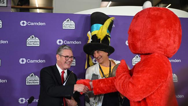 Keir Starmer is congratulated by fellow candidates Bobby 'Elmo' Smith, right, and Nick 'The Flying Brick' Delves after winning his London seat. Picture: AFP