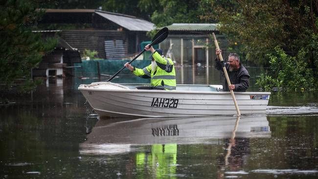 A boat was the best mode of transport for these two men in Western Sydney. Picture: David Gray/Getty Images