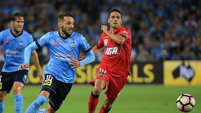 Sydney’s Milos Ninkovic and Adelaide United’s Marcelo Carrusca pursue a loose ball at Allianz Stadium. Picture: Mark Evans.
