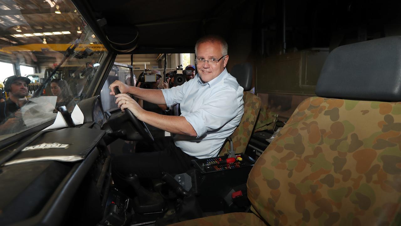 Scott Morrison poses in a military vehicle during his campaign trip to Darwin today. Picture: Gary Ramage