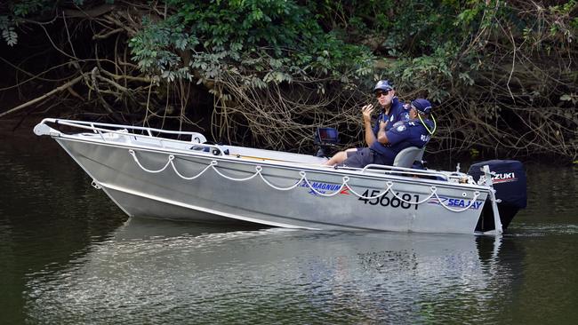 Queensland Police officers search the Barron River between the Kamerunga bridge and the cane rail bridge for a 27-year-old Cairns man missing since Wednesday, July 19. Picture: Brendan Radke