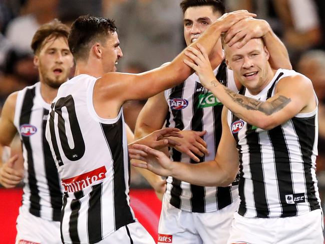 MELBOURNE, AUSTRALIA - MARCH 28: Jordan De Goey of the Magpies celebrates a goal with Scott Pendlebury of the Magpies and Brayden Maynard of the Magpies during the 2019 AFL round 02 match between the Richmond Tigers and the Collingwood Magpies at the Melbourne Cricket Ground on March 28, 2019 in Melbourne, Australia. (Photo by Dylan Burns/AFL Photos)