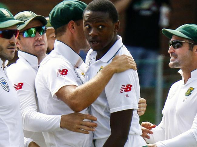 FILE -- In this March 9, 2018 file photo South Africa's bowler Kagiso Rabada, second right, celebrates a wicket with team mates during the second cricket test match between South Africa and Australia at St George's Park in Port Elizabeth, South Africa, Rabada has been banned for the rest of the series against Australia after being found guilty of two charges of misconduct for aggressive wicket celebrations. (AP Photo/Michael Sheehan, File)