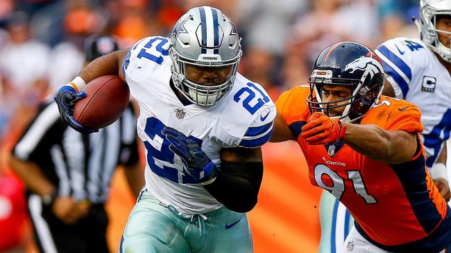A rare run for Ezekiel Elliott #21 of the Dallas Cowboys rushing against the Denver Broncos.