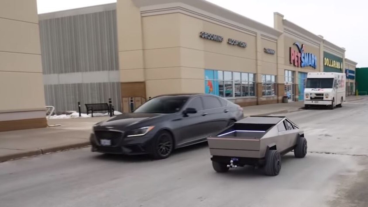 The scale model Cybertruck is dwarfed by a regular sedan. Picture: Hacksmith Industries