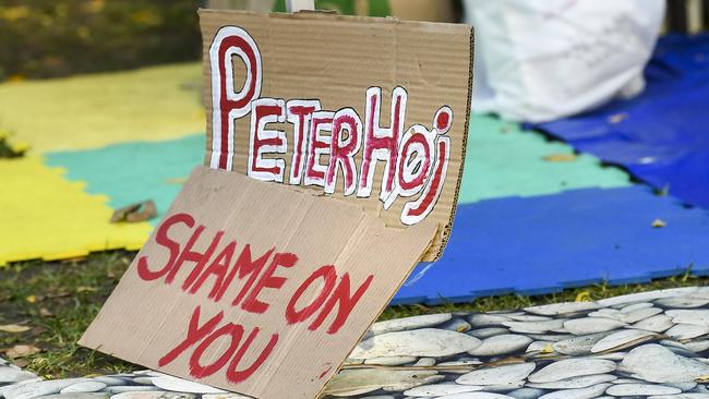 A sign on the lawn targets Adelaide University vice chancellor Peter Hoj. Picture: Mark Brake