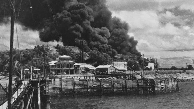 This is a black-and-white photograph showing damage from a Japanese bomb attack to an oil storage site on Stokes Hill, above Darwin harbour, in the Northern Territory in 1942. Picture: Creative Commons