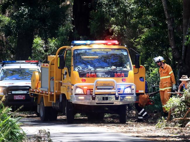 Queensland Rural Fire Service personnel help with the clean-up on the Gold Coast. Picture: Scott Powick/NCA NewsWire