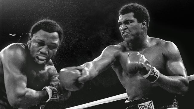 Spray flies from the head of Joe Frazier, left, as Muhammad Ali connects with a right in the ninth round of their title fight in Manila.
