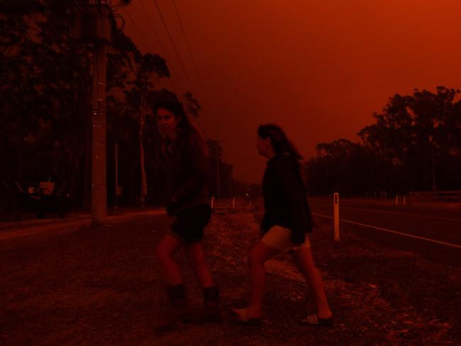 Residents watch the developing conditions near the town of Sussex Inlet on December 31, 2019 in Sydney, Australia. There are a number of dangerous bushfires burning at emergency level across NSW as weather conditions deteriorate with temperatures expected to rise ahead of gusty southerly change. Princes Highway on the NSW South Coast has been closed with motorists told to avoid all non essential travel. Volunteer firefighter Sam McPaul was killed when his truck rolled over in a freak wind event near Jingellic near the NSW-Victorian border on Monday evening. Picture: Sam Mooy/Getty