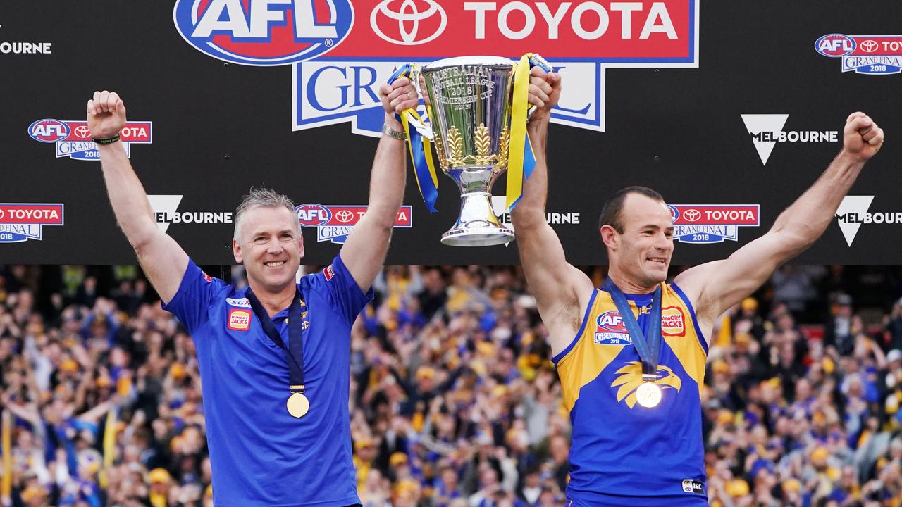 Adam Simpson and Shannon Hurn of the Eagles hold up the premiership cup in 2018. Photo by Michael Dodge/AFL Media/Getty Images.