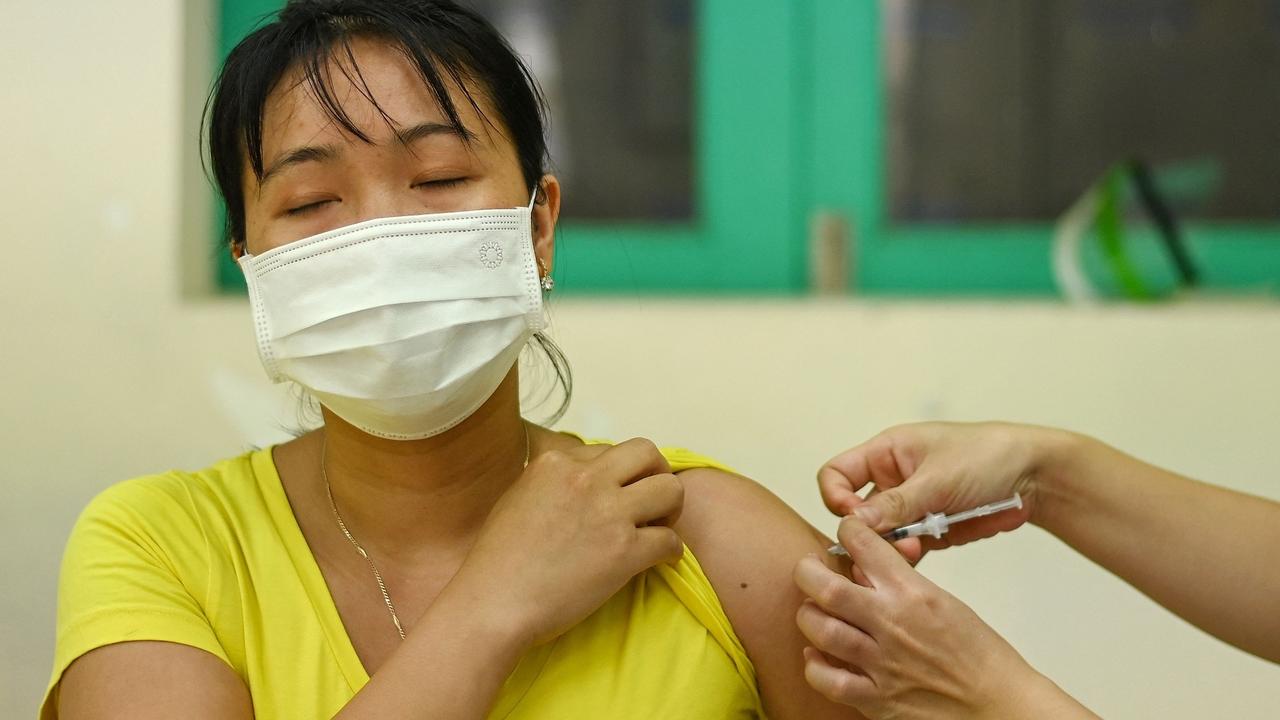 A woman receives the AstraZeneca vaccine in Hanoi. Picture: Manan Vatsyayana/AFP