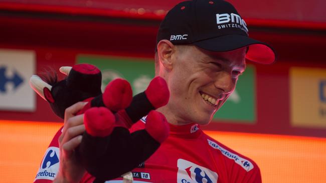 BMC Racing Team's Australian cyclist Rohan Dennis smiles on the podium as he celebrates winning the first stage of the 73rd edition of "La Vuelta" Tour of Spain cycling race, an 8 km individual time trial from Malaga to Malaga, on August 25, 2018. (Photo by JORGE GUERRERO / AFP)