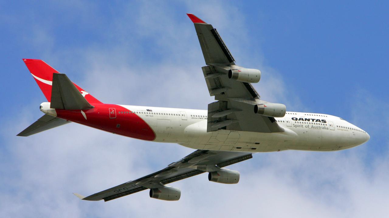 A Qantas plane takes off from Brisbane Airport.