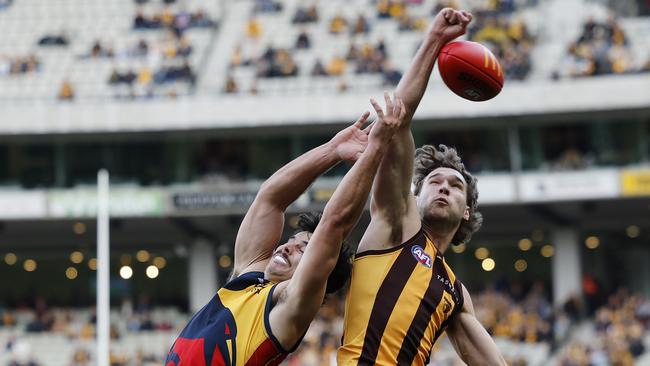 MELBOURNE , AUSTRALIA. June 1, 2024.  AFL Round 12.  Hawthorn vs Adelaide at the MCG . Jack Scrimshaw of the Hawks punches the ball away from Darcy Fogarty of the Crows during the 1st qtr.        . Pic: Michael Klein