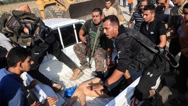 Palestinian militants surround a truck carrying a captured Israeli woman. Picture: AFP