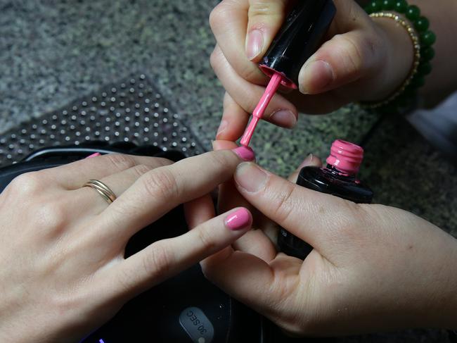 Julia Bussa, 18, Aspley, having her nails painted at American Nails salon in Chermside where they use ultraviolet light to dry nail polish. Cancer experts are warning Queenslanders to regularly check beneath their nails for signs of melanoma and to wear sunscreen to nail salons . Photographer: Liam Kidston.