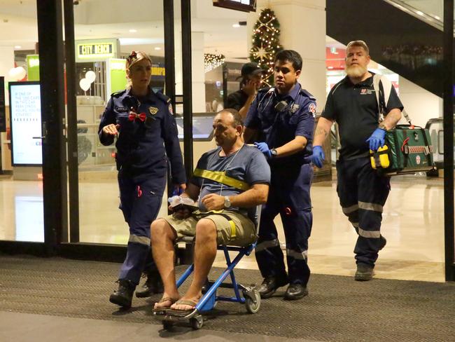 A man is wheeled out of the shopping centre after the crowd crush. Picture: Bill Hearne