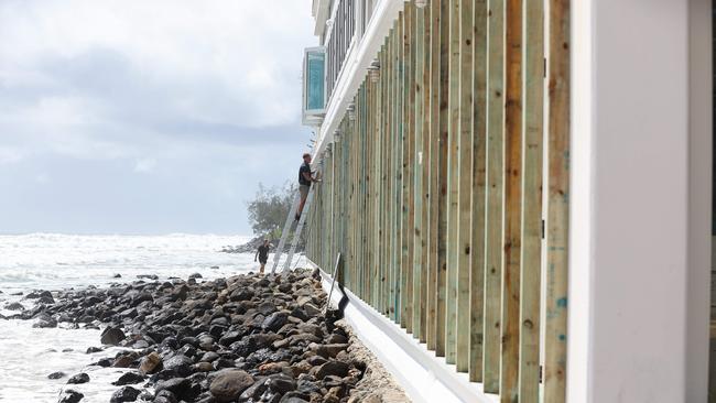 Burleigh restaurant Rick Shores puts works in place to protect what they can from the incoming Cyclone Alfred. Picture: Adam Head