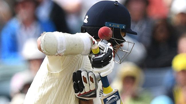 England batsman James Anderson is struck by the ball bowled by Australia's Pat Cummins. Picture: AAP.