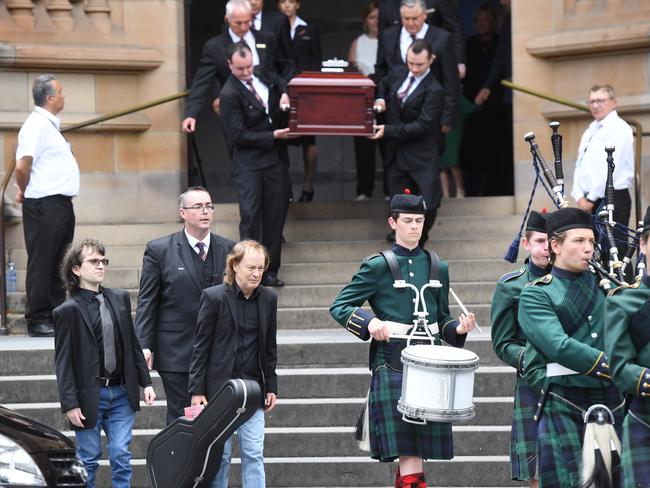 Angus Young, left, carrying the guitar. Picture: AAP