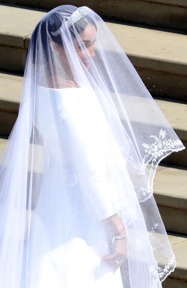 Markle’s smiles were obvious underneath her 4.8 metre veil. Picture: Andrew Matthews/AFP