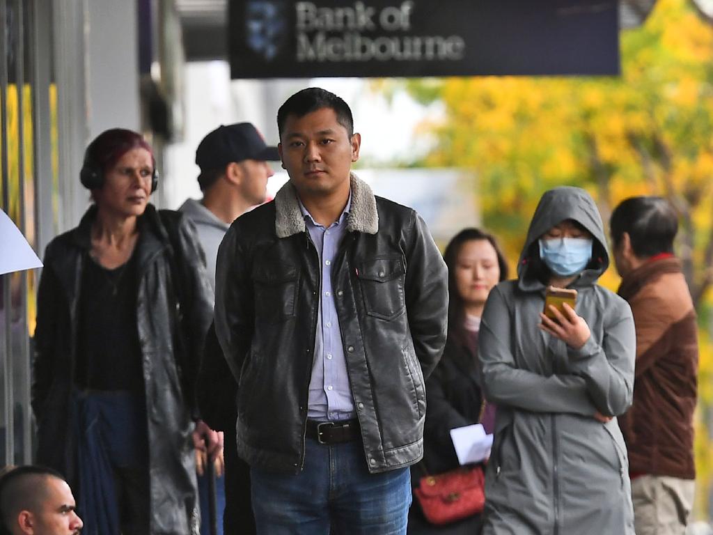 People queue up outside a Centrelink office in Melbourne in April. Picture: William WEST / AFP.