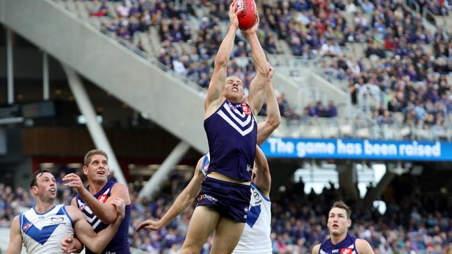 Nat Fyfe leaps high to mark.