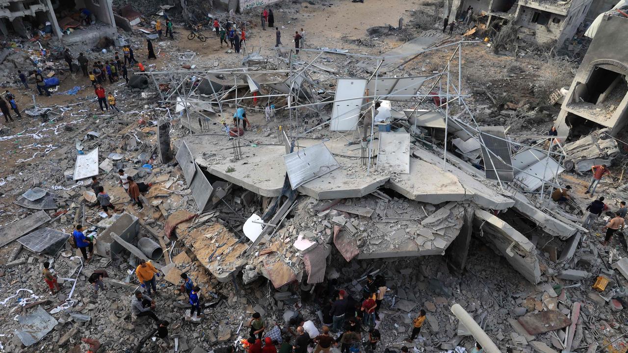 This aerial picture shows people gathered around a destroyed building following Israeli bombing on Rafah in the southern Gaza Strip, on November 11. Picture: AFP