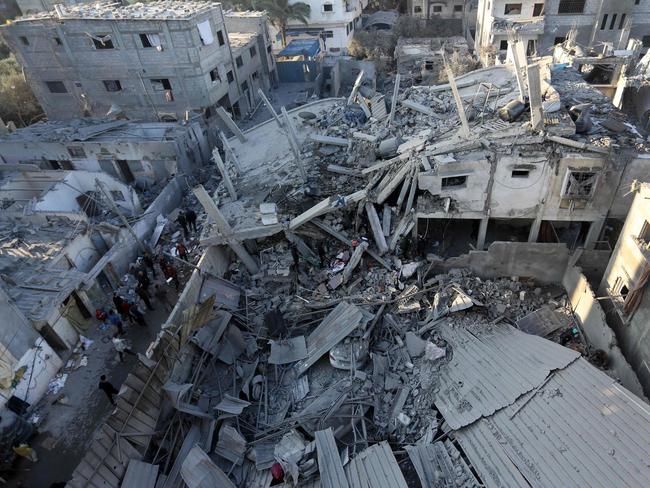 Palestinians inspect the damage following Israeli strikes on the Zawayda area of the central Gaza Strip. Picture: AFP