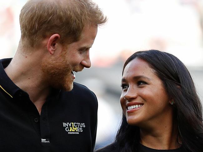 Britain's Prince Harry, Duke of Sussex and Britain's Meghan, Duchess of Sussex arrive on the field prior to the start of the first of a two-game series between  the New York Yankees and the Boston Red Sox at London Stadium in Queen Elizabeth Olympic Park, east London on June 29, 2019. - As Major League Baseball prepares to make history in London, New York Yankees manager Aaron Boone and Boston Red Sox coach Alex Cora are united in their desire to make the ground-breaking trip memorable on and off the field. (Photo by PETER NICHOLLS / POOL / AFP)