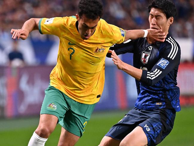 SAITAMA, JAPAN - OCTOBER 15: Nishan Velupillay of Australia controls the ball against Daichi Kamada of Japan during the FIFA World Cup Asian Third Qualifier Group C match between Japan and Australia at Saitama Stadium on October 15, 2024 in Saitama, Japan.  (Photo by Kenta Harada/Getty Images)