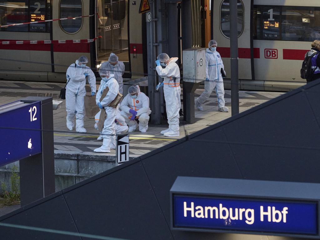 Investigators work at Hamburg Central Station after a knife attack during peak hour. Picture: Georg Wendt / dpa / AP