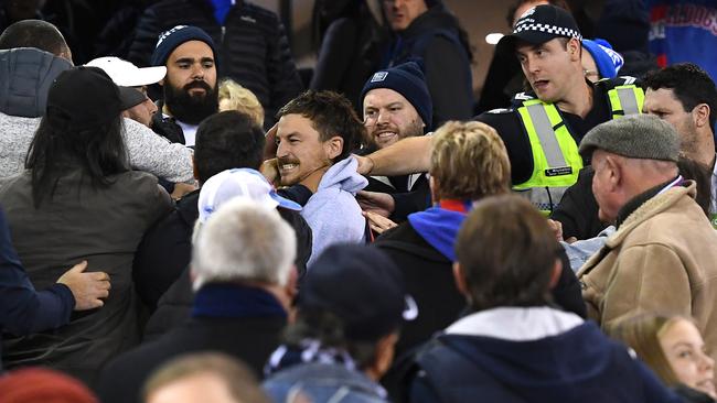 Police try to separate a fight in the crowd at the Carlton-Western Bulldogs game. Picture: Quinn Rooney/Getty Images