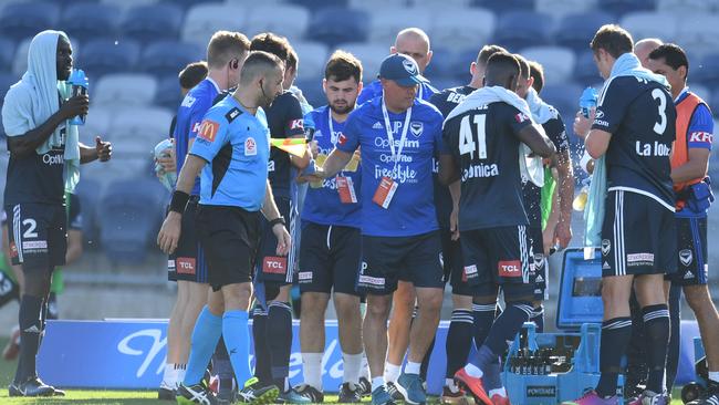 Victory players have a drink during a break in the first half. Picture: AAP