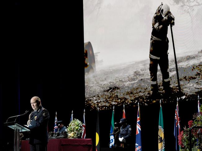 Mr Fitzsimmons speaks during the Bushfire State Memorial as images from Australia’s bushfires are revealed in the background. Picture: Bianca De Marchi/AAP