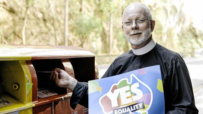 VOTE CAST: The Dean of Brisbane Dr Peter Catt posts his yes vote in the city recently. He explains why his church and many others are in favour of marriage equality.