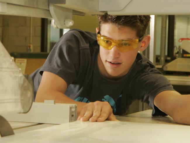 Generic photo of an capentry apprentice and student working a circular saw at a TAFE college.