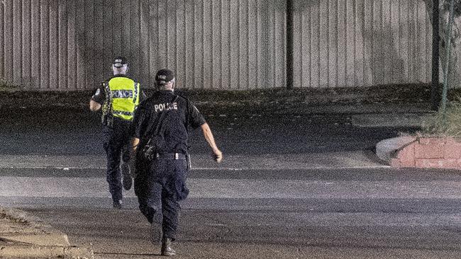 Police officers on the run chasing a group of young children on the streets of Alice Springs at night. Picture: Mark Brake