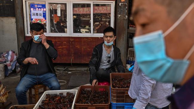 Vendors wearing face masks at the Wuhan Baishazhou Market in Wuhan in China's central Hubei province.