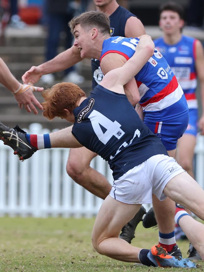 Bulldog Harry Grant is tackled by South Adelaide’s Joseph Haines in the Round 14 clash at Elizabeth Oval. Picture: David Mariuz/SANFL