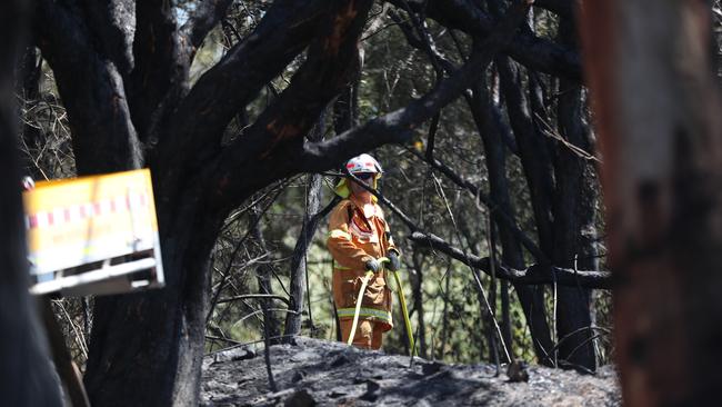 Firefighters and water bombing helicopters fight fires on the Sunshine Coast. Pic Peter Wallis
