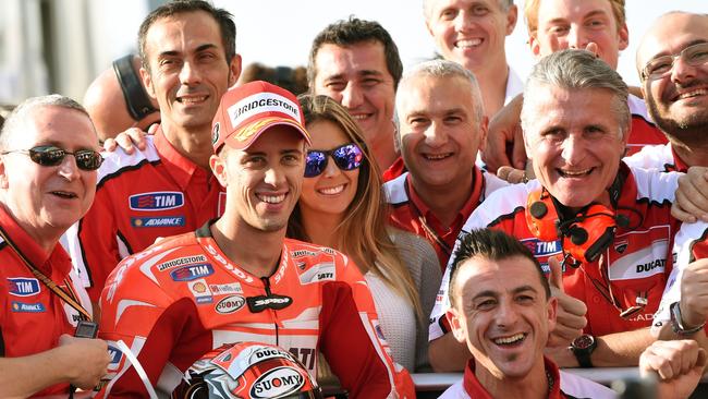 Ducati Team rider Andrea Dovizioso of Italy with his team officer and mechanics.