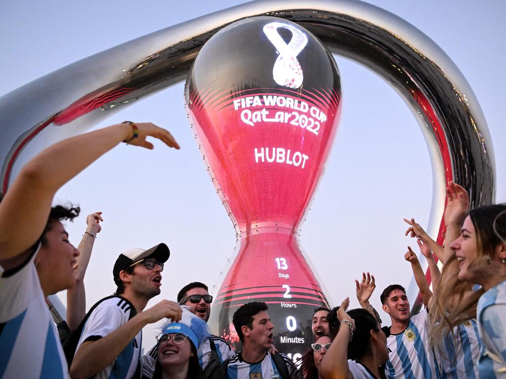 Argentina's fans cheer in front of the FIFA World Cup countdown clock in Doha on November 7, 2022, ahead of the Qatar 2022 FIFA World Cup football tournament. (Photo by Kirill KUDRYAVTSEV / AFP)