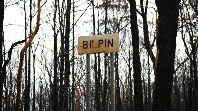 A sign damaged by fire at Bilpin, Monday, January 13. The landscape was just ‘sticks in the ground’ after fire tore through the forest. Picture: AAP