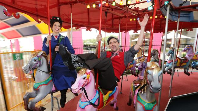 Gold Coast Mary Poppins stars Georgina Hopson and Max Patterson ride the Carousel at Broadbeach to publicise their musical. Picture Glenn Hampson