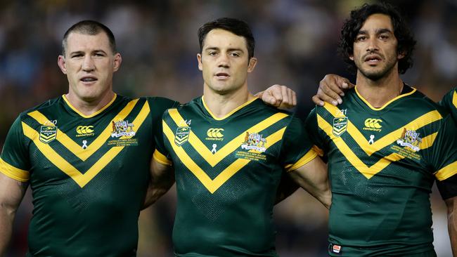 Paul Gallen, Cooper Cronk and Johnathan Thurston sing the national anthem.