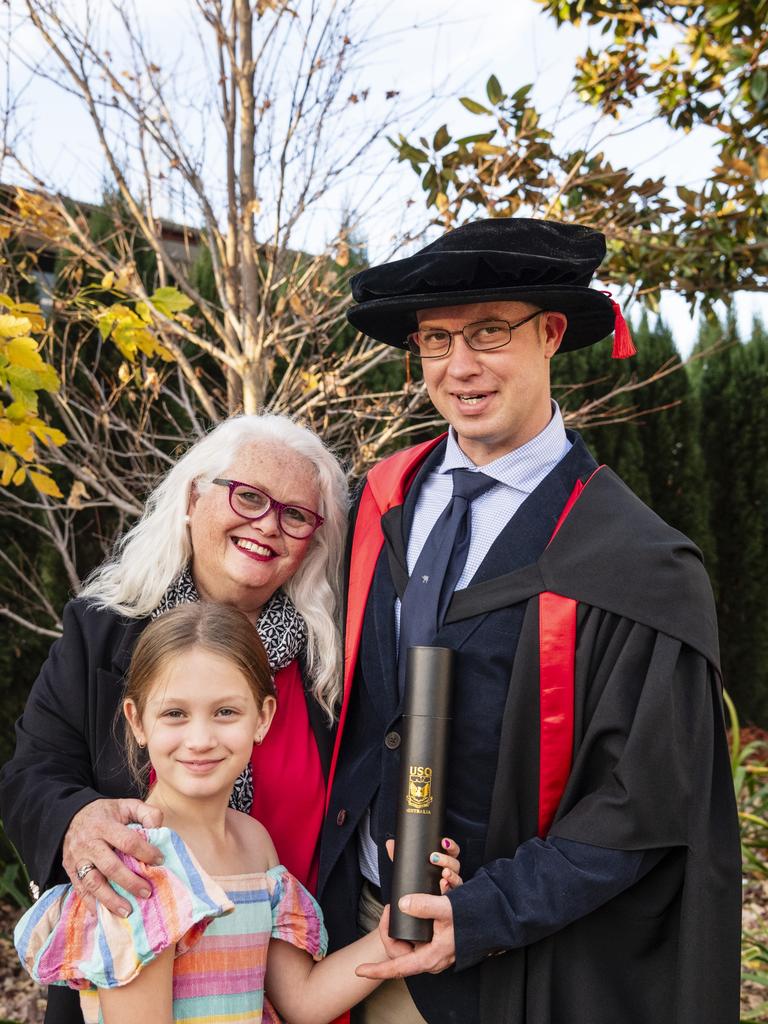 Doctor of Philosophy graduate Tom Redmond with mum Bernadette Redmond and daughter Charlotte Redmond at a UniSQ graduation ceremony at Empire Theatres, Wednesday, June 28, 2023. Picture: Kevin Farmer