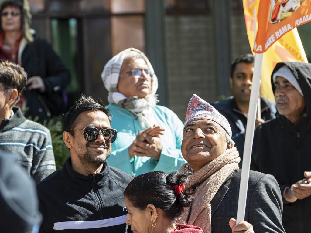 Thakur Prasad Poudel (right) watches the Hare Krishna flag fly as he holds it during Toowoomba's Festival of Chariots, Saturday, July 20, 2024. Picture: Kevin Farmer